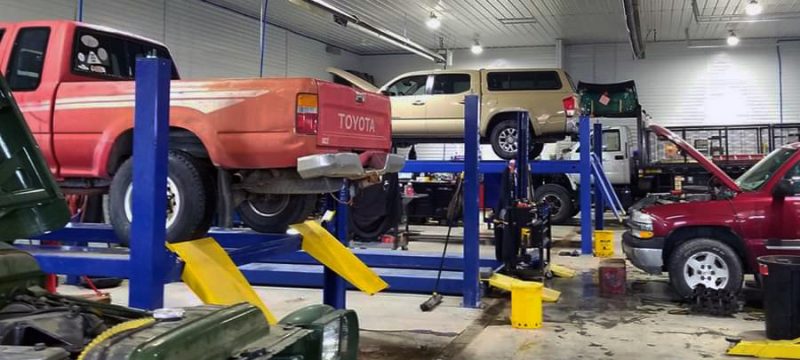 auto repair shop with cars on the lift